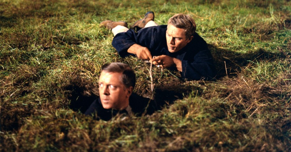 Steve McQueen and Richard Attenborough surface outside the PoW camp in the film