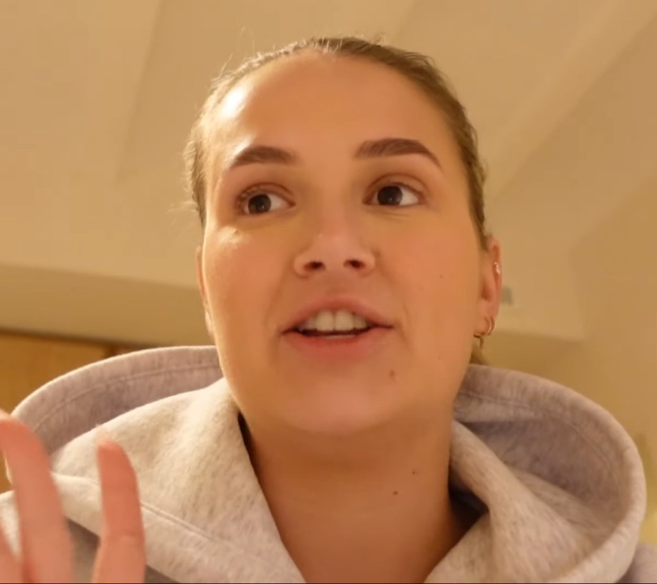 a close up of a woman 's face with a hoodie on