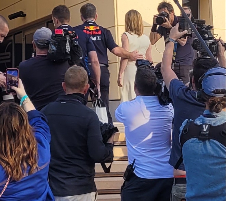 Horner put his hand gently on his wife's back as he escorted her through the crowd