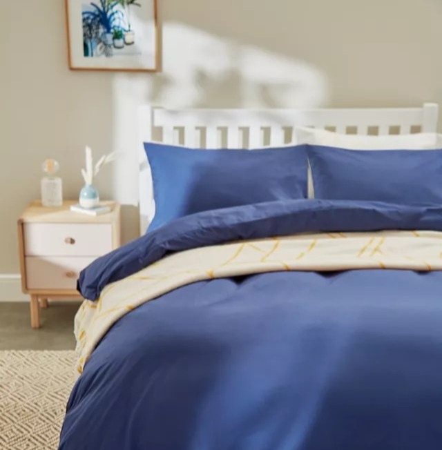 Blue duvet cover on a bed.