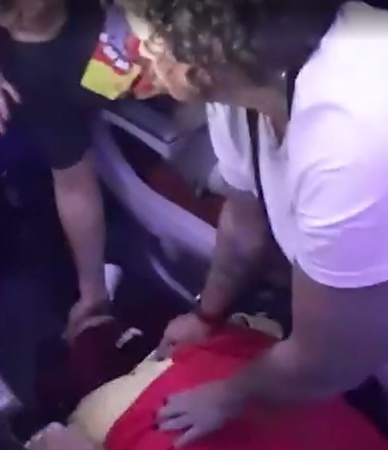 People appear to be rescuing a fellow passenger on the floor of the LATAM airlines flight