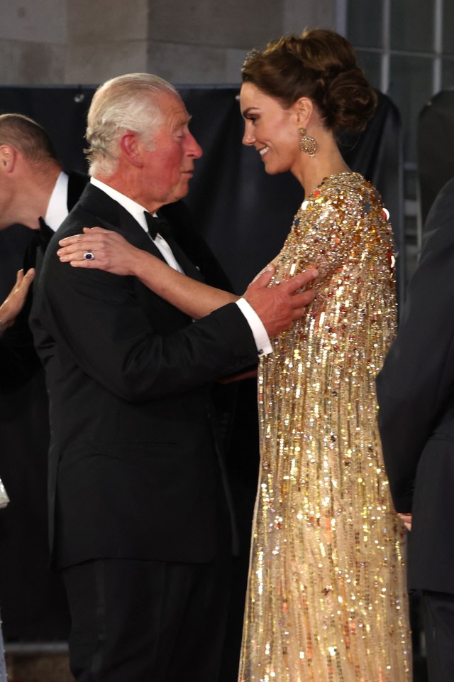 Britain's Prince Charles, Prince of Wales (L) kisses Britain's Catherine, Duchess of Cambridge as they arrive for the World Premiere of the James Bond 007 film "No Time to Die" at the Royal Albert Hall in west London on September 28, 2021. - Celebrities and royals walk the red carpet in central London on Tuesday for the star-studded but much-delayed world premiere of the latest James Bond film, "No Time To Die". (Photo by Chris Jackson / POOL / AFP) (Photo by CHRIS JACKSON/POOL/AFP via Getty Images)