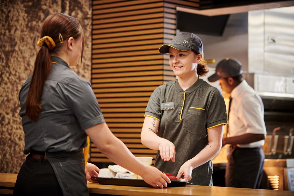 McDonalds staff wearing the old grey and yellow polo top with a baseball cap