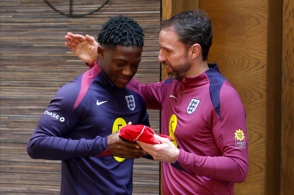 Kobbie receives his England cap from Gareth Southgate