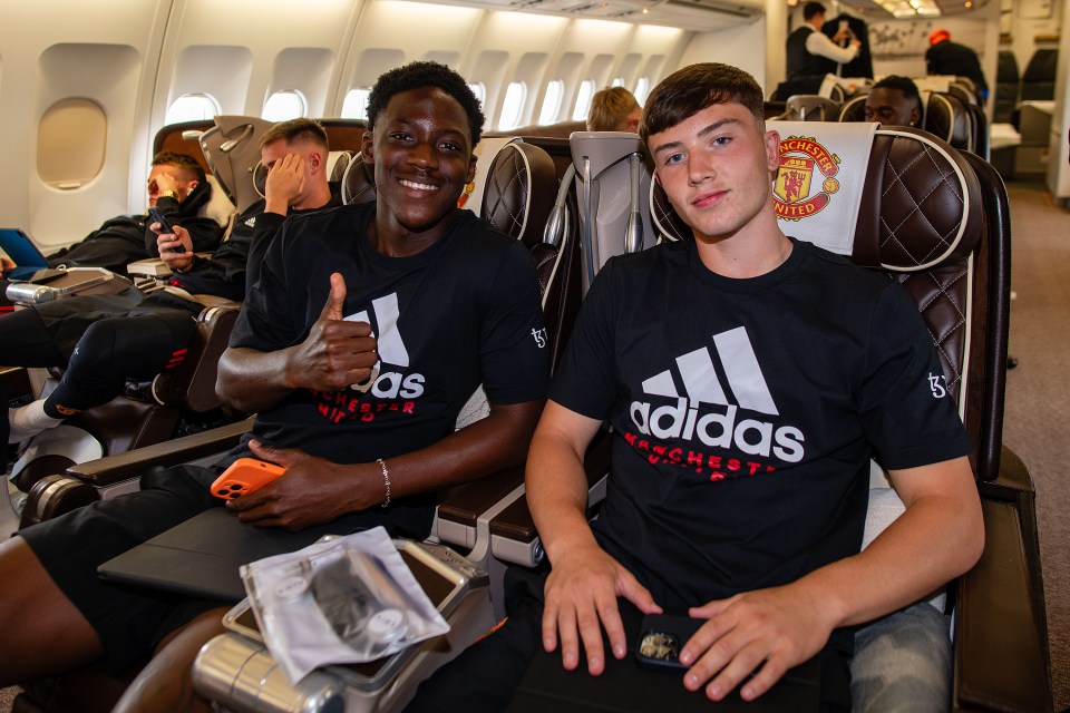 Kobbie seated next to Daniel Gore as they headed to the US last July