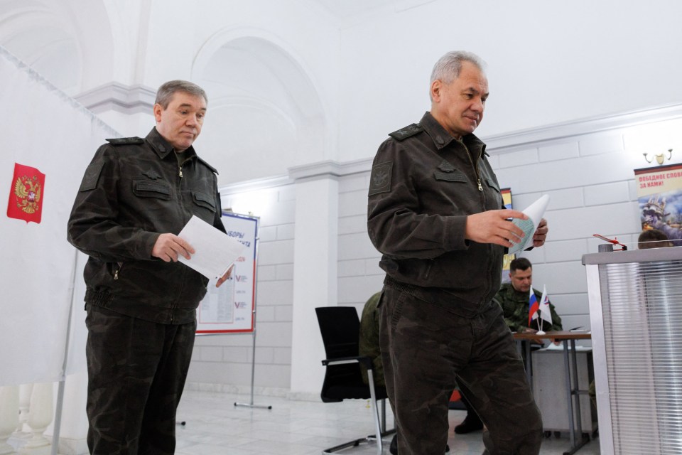 Army chief of staff Valery Gerasimov, left, and Defence Minister Sergei Shoigu vote