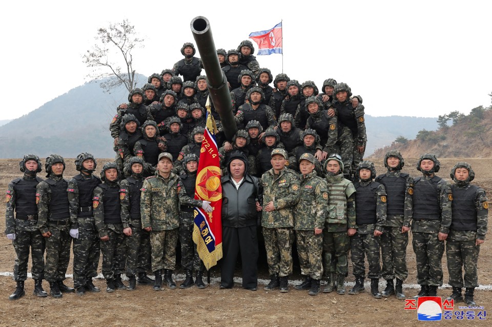 Dictator Kim poses with his troops during the exercises