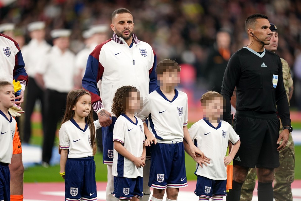 England’s Kyle Walker with three of his kids, right, ahead of the international friendly match at Wembley Stadium