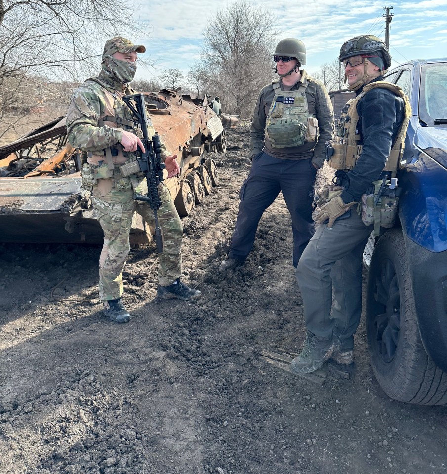 A Ukrainian soldier greets Will, centre, and convoy