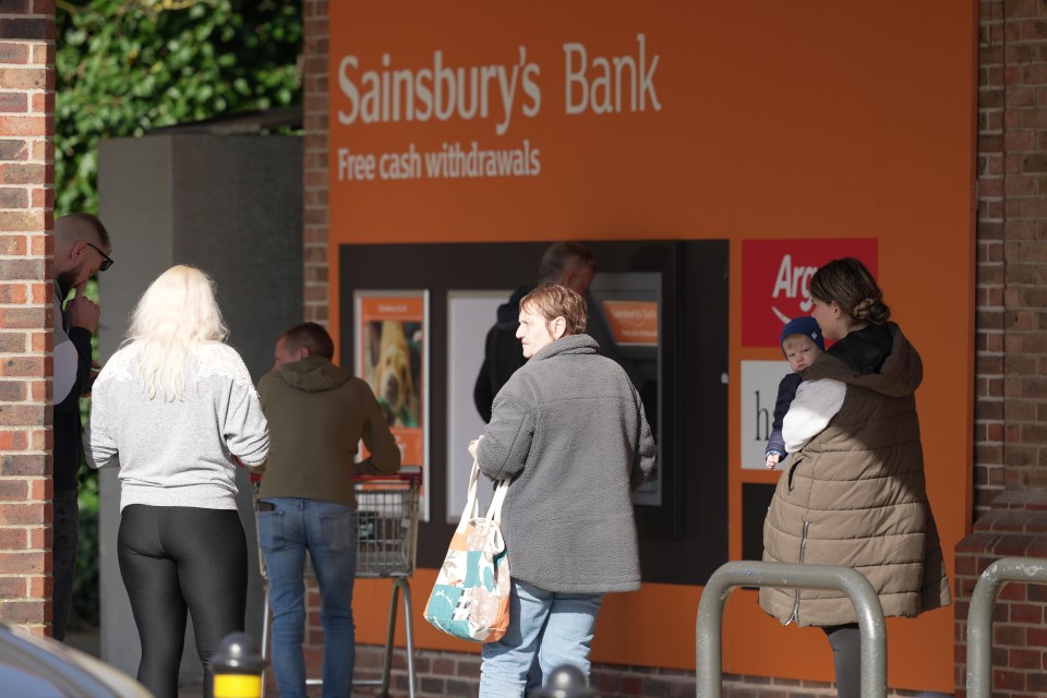 Shoppers lined up for an ATM to withdraw cash