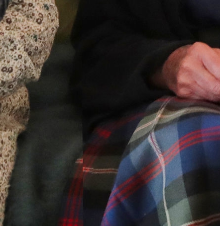 A mismatched line cuts through the pattern on the Queen’s tartan skirt in the image