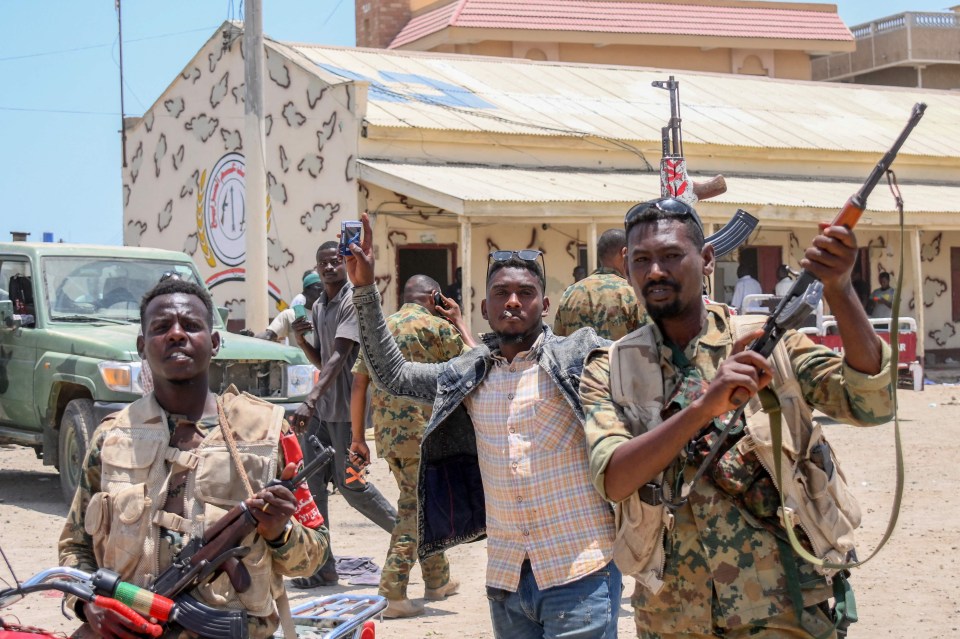 Sudanese army soldiers, loyal to army chief Abdel Fattah al-Burhan, pose for a picture at the RSF base in the Red Sea city of Port Sudan in April last year