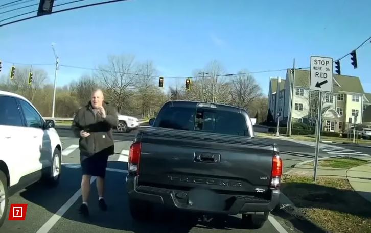 After Brocuglio honked, Ganter got out of his truck and waved his badge at him