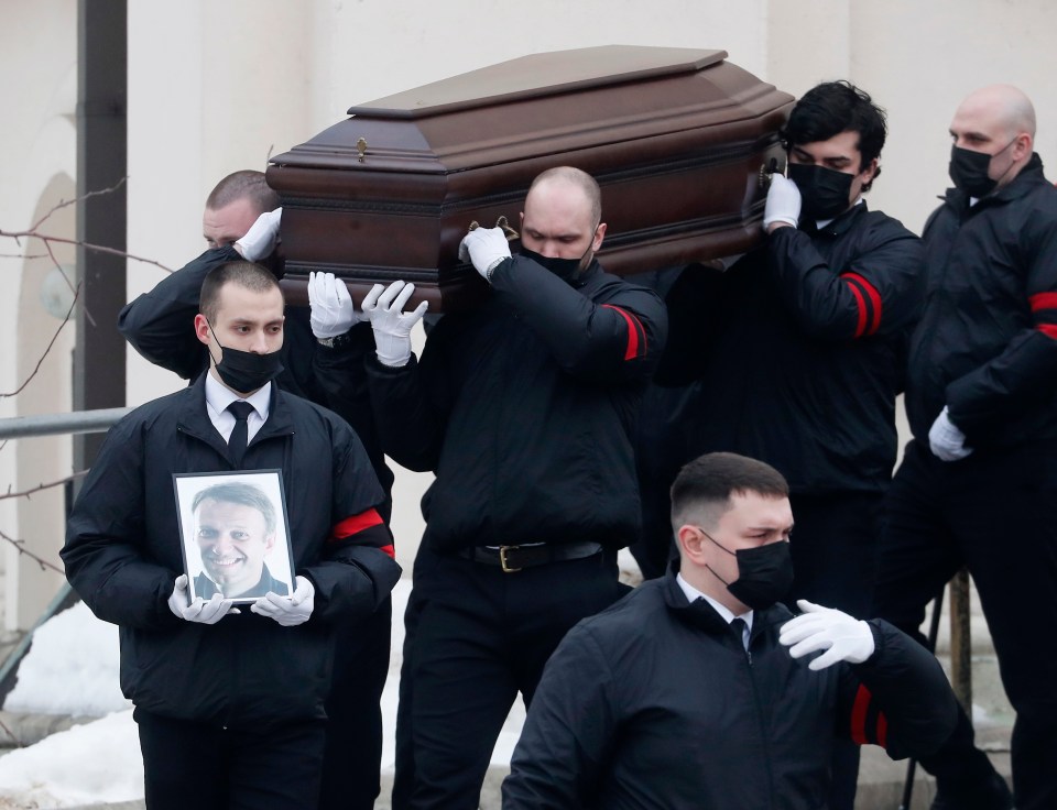 Workers carry the coffin of Navalny to the Church of the Icon of the Mother of God Soothe My Sorrows