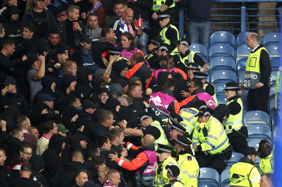 Fans clash with police in the stands during a Europa League match