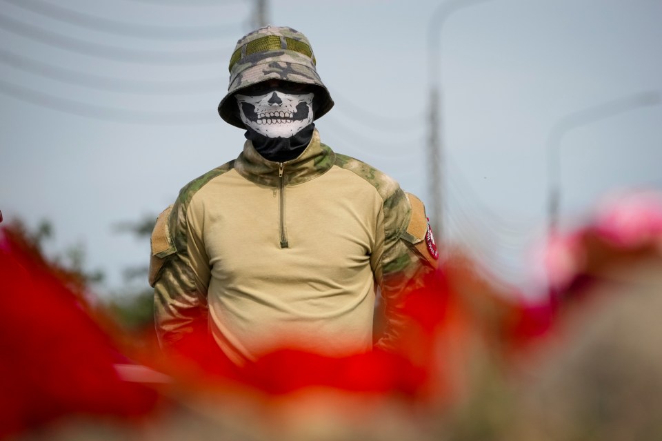 A fighter of the Wagner private military force stands at an informal memorial next to the former ‘PMC Wagner Centre’ in St Petersburg, Russia