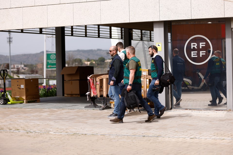 A Europol agent and several agents from the Guardia Civil’s Central Operational Unit leave the Royal Spanish Football Federation last week in Madrid