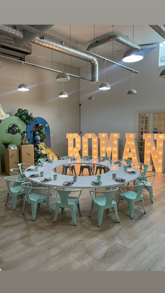 An elaborate circular table was laid out against a stunning backdrop with giant letters spelling out her son's name in lights