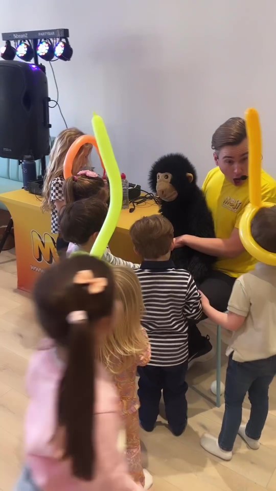 An entertainer was hired with a puppet monkey who made balloon animals for the kids