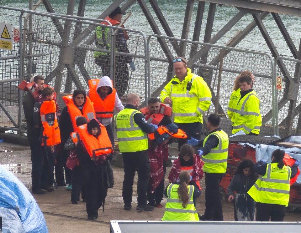 Men, women, and children are brought safely ashore in Dover