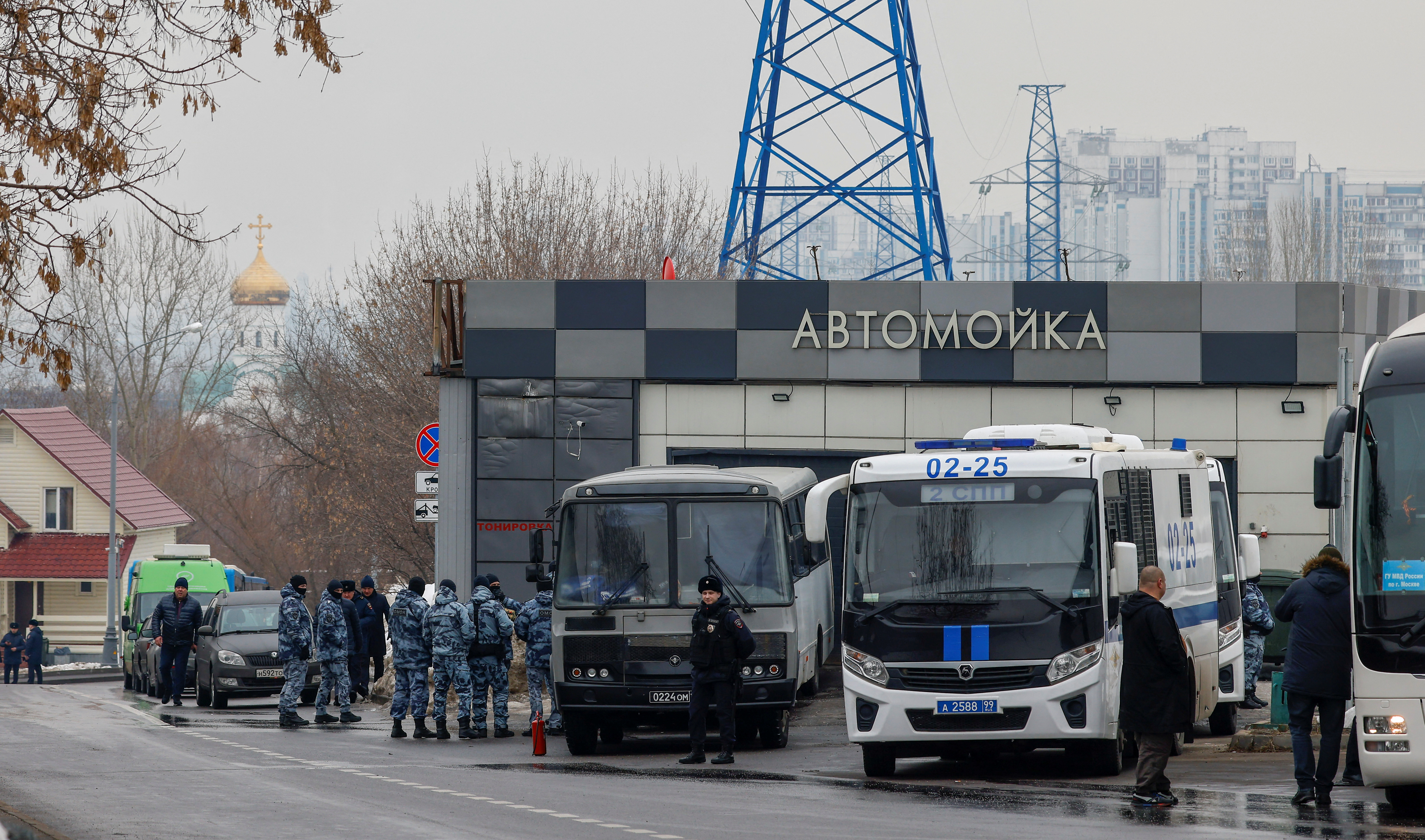 Law enforcement officers gather near the Borisovskoye Cemetery