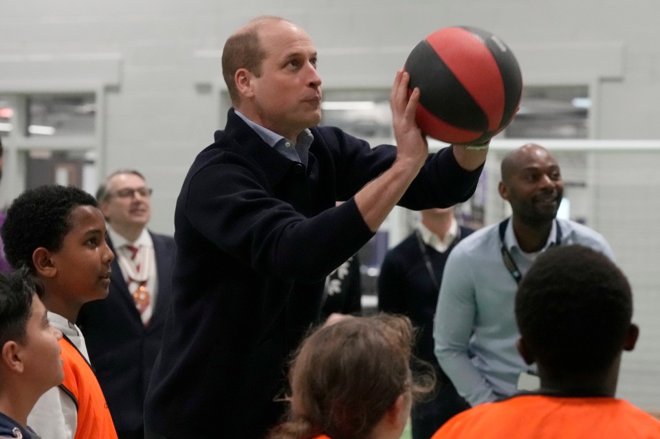 Prince William concentrated as he got to shoot a basket ball