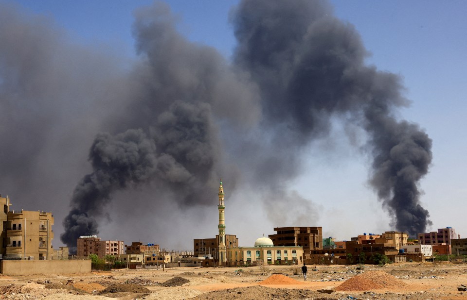 Smoke rises above buildings after aerial bombardment amid clashes between the RSF and the SAF