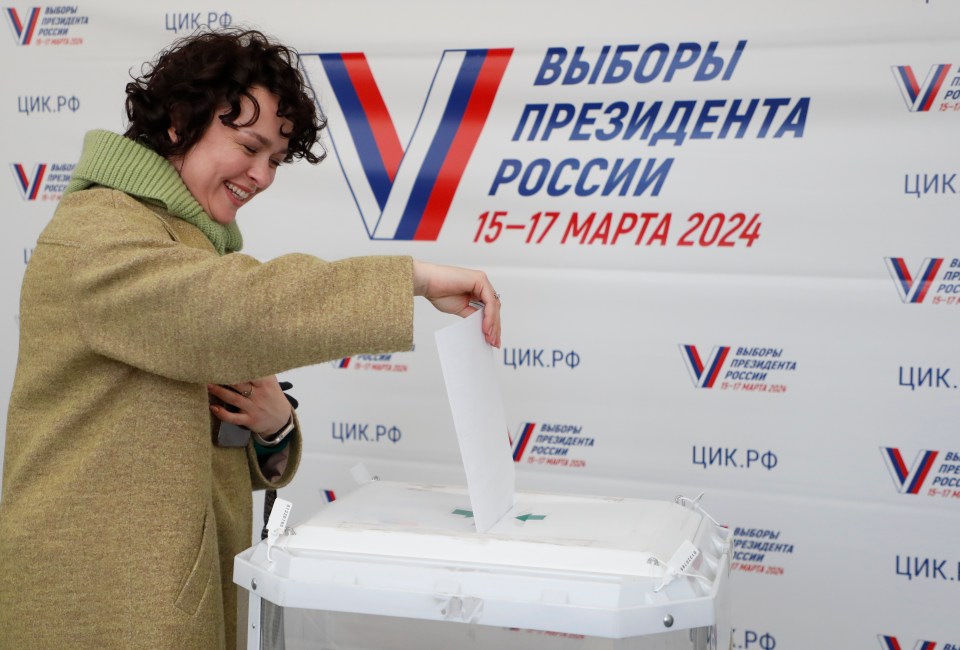 A Russian woman casts her ballot in Moscow today