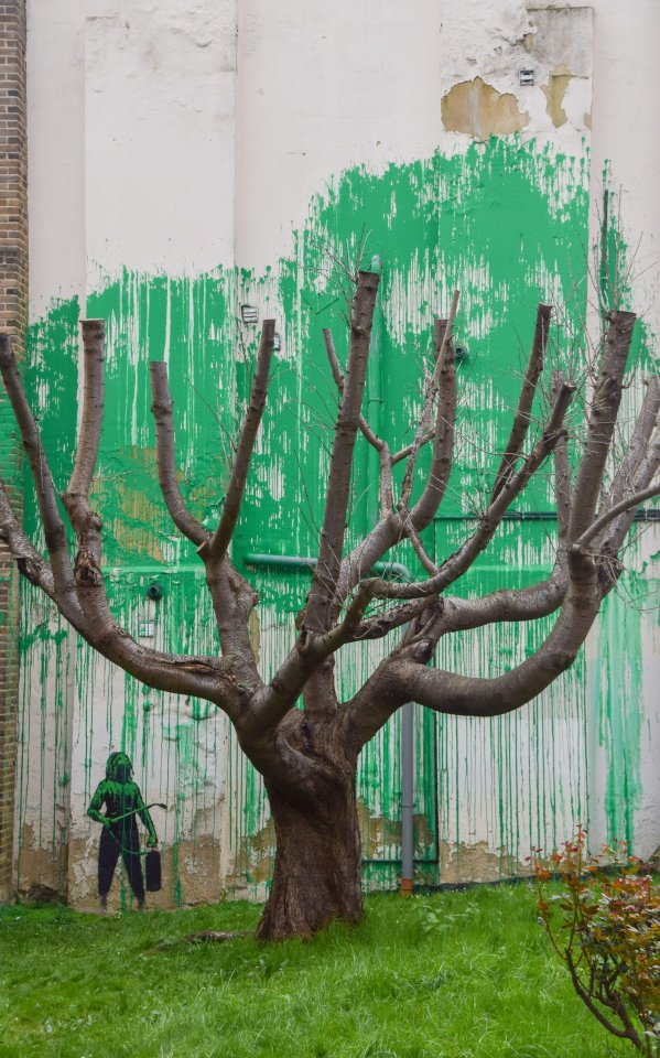 The splash of green paint coincides with where the leaves would be on the real tree