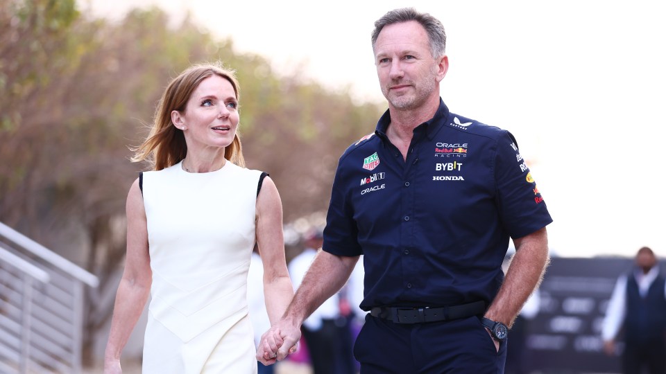 BAHRAIN, BAHRAIN – MARCH 02: Oracle Red Bull Racing Team Principal Christian Horner and Geri Horner walk in the Paddock holding hands prior to the F1 Grand Prix of Bahrain at Bahrain International Circuit on March 02, 2024 in Bahrain, Bahrain. (Photo by Bryn Lennon – Formula 1/Formula 1 via Getty Images)