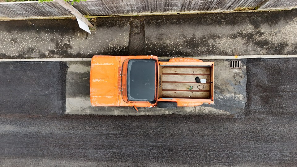 The slice of road that was used by the old car now sticks out like a sore thumb