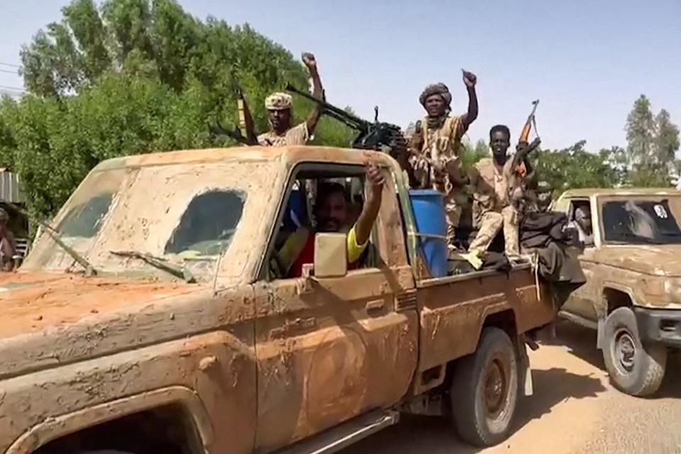 RSF fighters ride in the back of a technical vehicle in the East Nile district of greater Khartoum