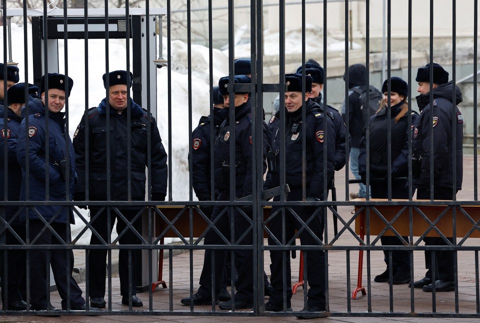 Police officers stand guard near the church