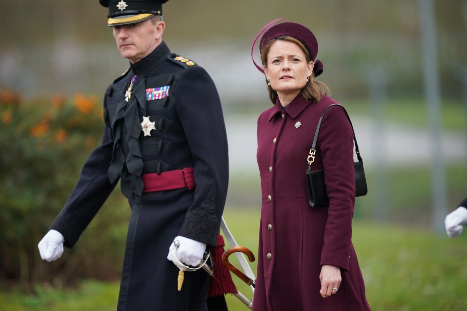 Dressed in a plum coat dress, she presented the Irish Guards' mascot, Seamus the dog, with a shamrock, as is tradition at the parade