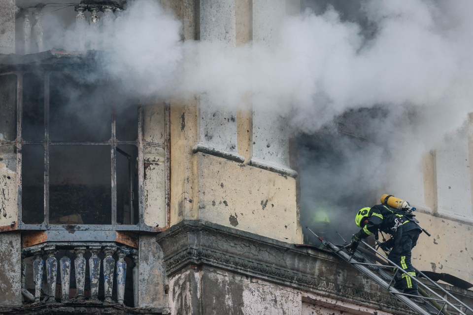 Rescuers work to put out fires caused by the attack