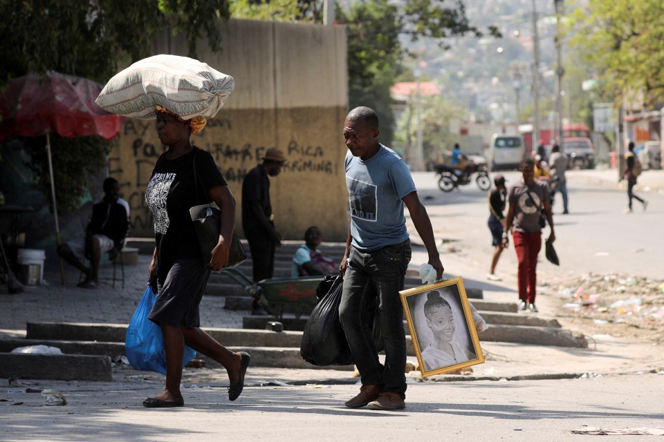 People carrying belongings as they flee their homes