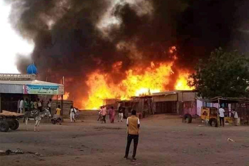 A man stands by as a fire rages in a livestock market area in al-Fasher, the capital of Sudan’s North Darfur state, in September last year