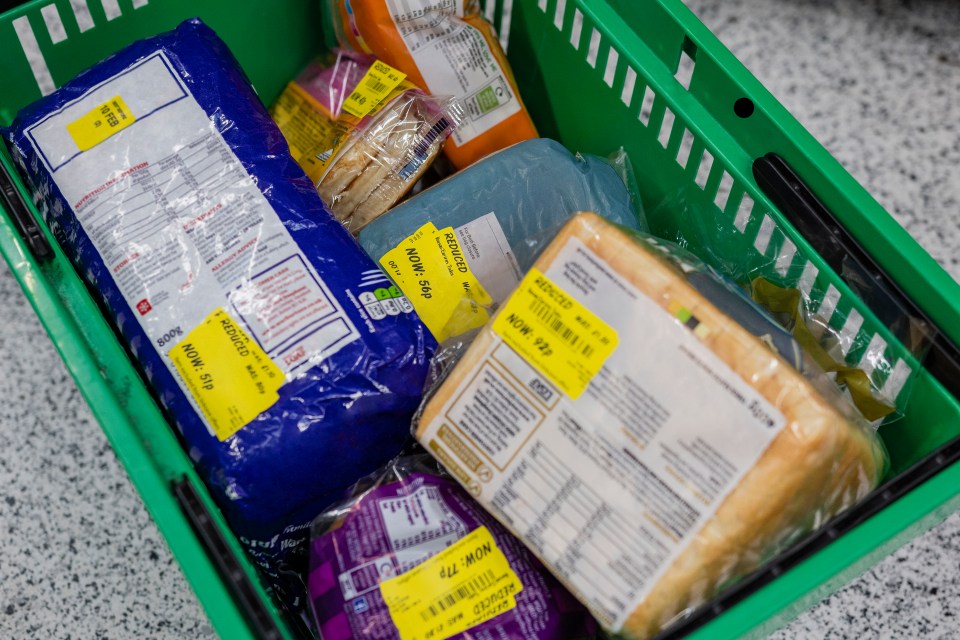 a green basket filled with groceries including a bag of bread that says now 79