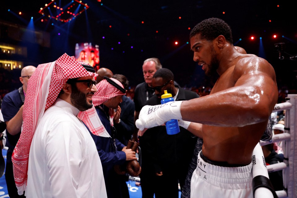 Boxing - Anthony Joshua v Francis Ngannou - Kingdom Arena, Riyadh, Saudi Arabia - March 9, 2024 Anthony Joshua celebrates with Turki bin Abdul Mohsen Al-Sheikh after winning his fight against Francis Ngannou REUTERS/Andrew Couldridge