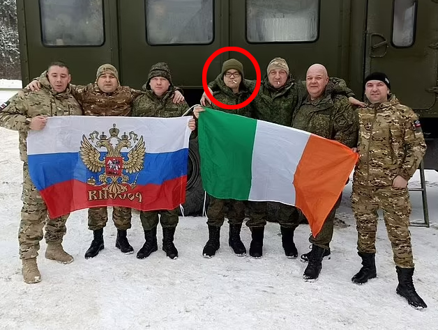 Minnis (circled) posing up proudly with an Irish flag next to troops holding a Russian flag