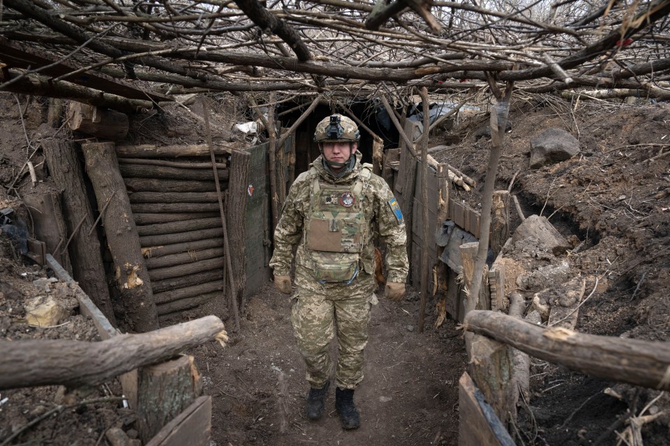 A soldier takes cover in a Ukrainian trench just days ago near the frontline