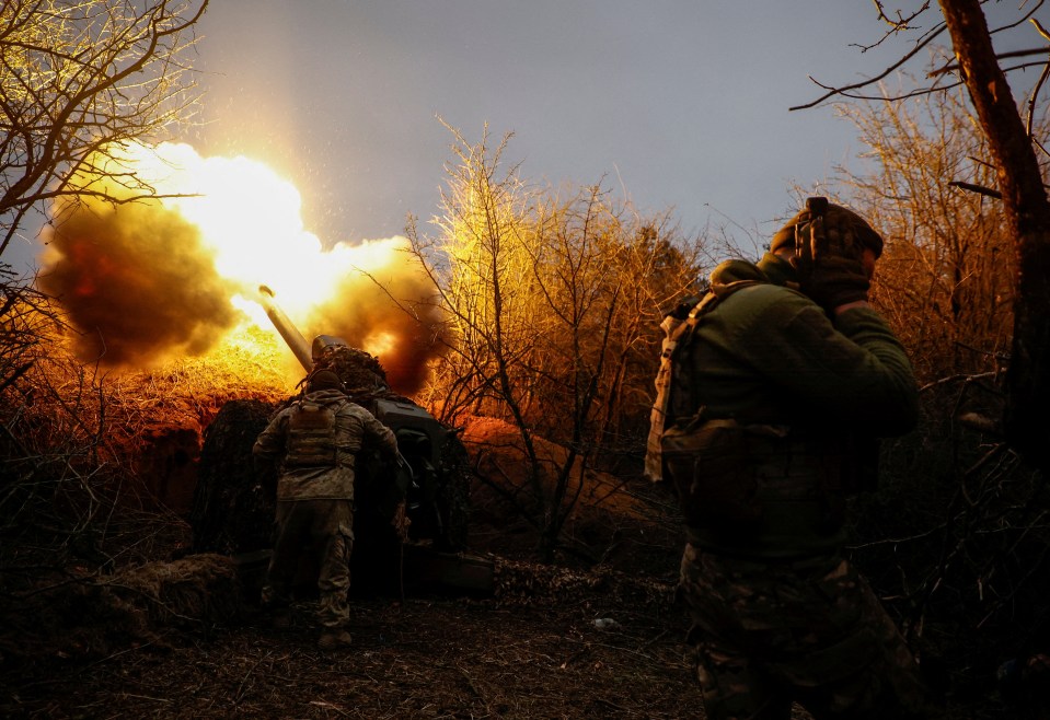 Ukrainian troops shoot at Russian positions on the frontline on March 12