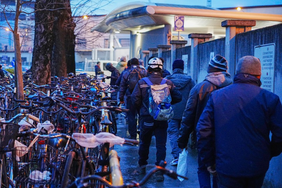 Migrant workers arrive for their morning shift at the Fincantieri ship yards