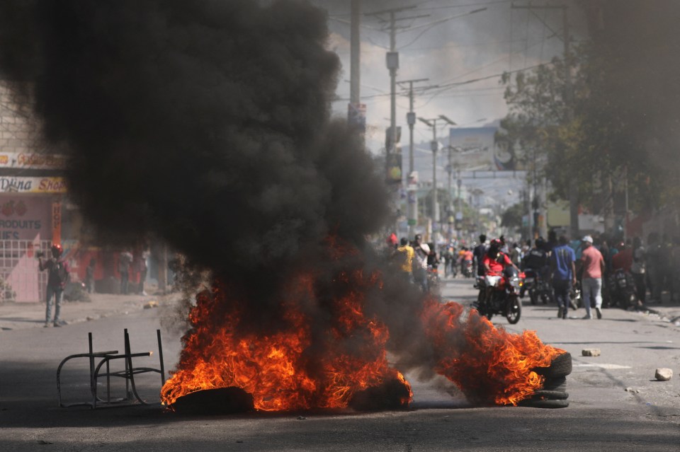 A burning barricade set up during the protests in Port-au-Prince