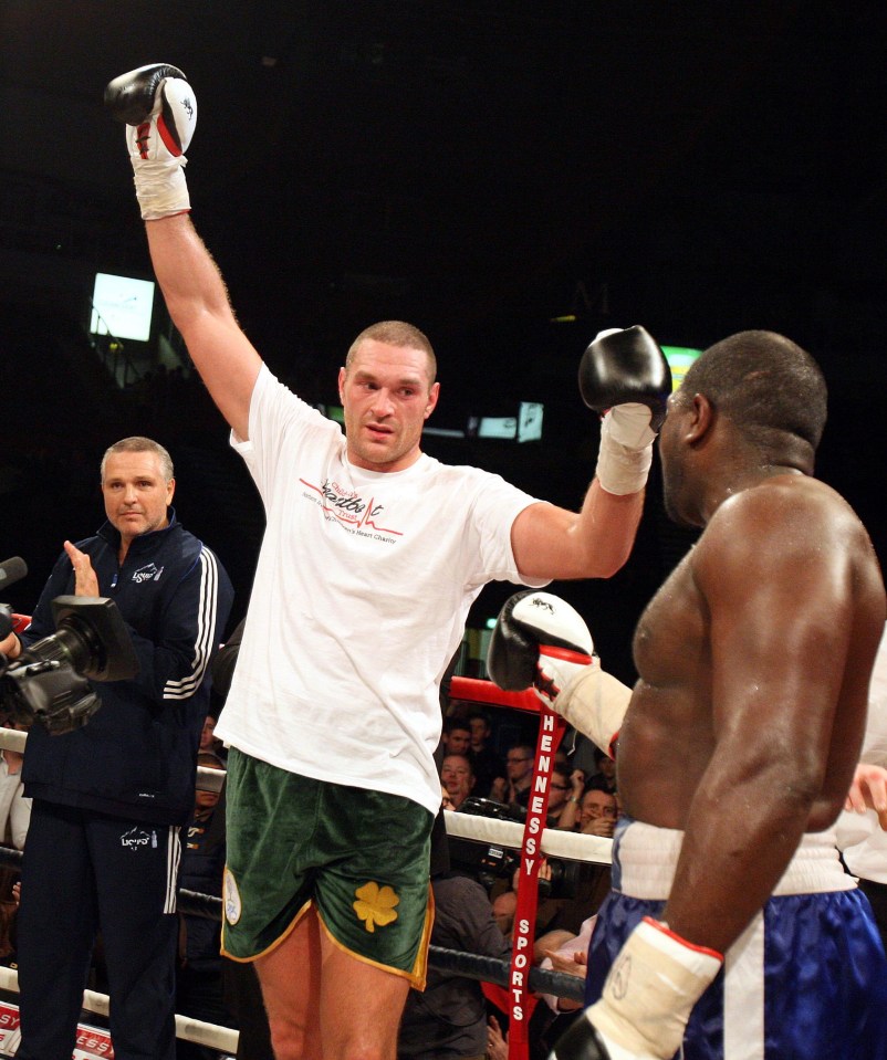 Tyson Fury (centre) celebrates defeating Kevin Johnson (right) in 2012