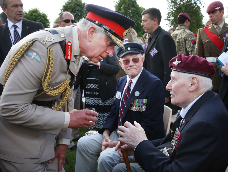 Charles meets with Normandy veterans Jim Beasant, right, and Douglas Coxell at the 70th anniversary of the landings