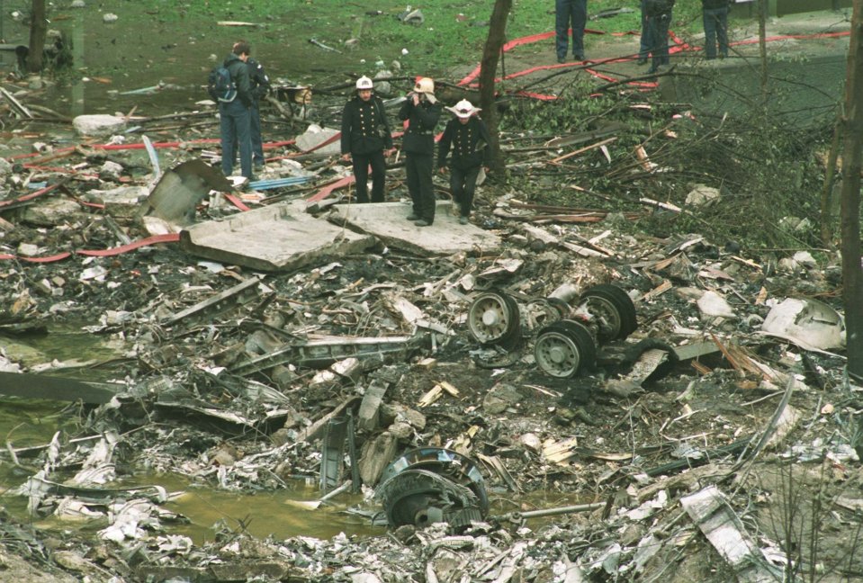 Firefighters inspect the wreckage of the El Al 747