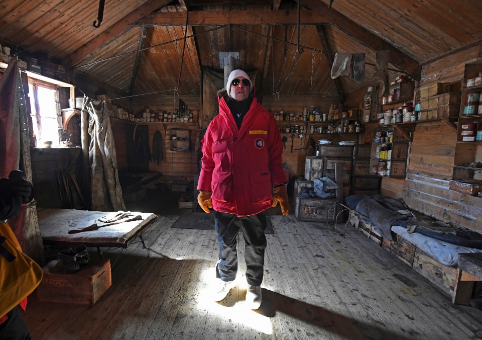 Former US Secretary of State John Kerry stands inside a hut near McMurdo Station