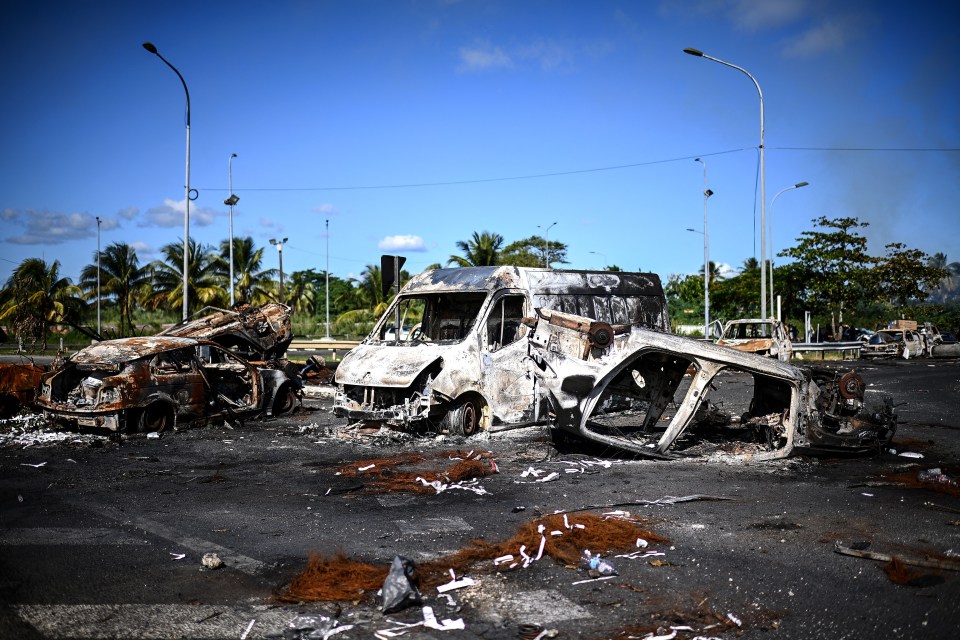 This photograph taken in November 2021 shows barricades made of burnt cars on the French Caribbean island of Guadeloupe