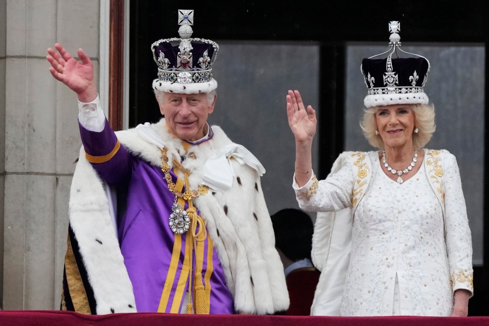 King Charles and Queen Camilla waving from the Buckingham Palace balcony at the coronation on May 6 2023